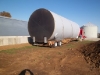 Truck backing 1st tank into position.
