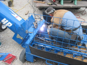 Dennis welding on new augur