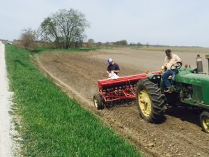 Blake and Leonard seeding a newly-graded ditch.